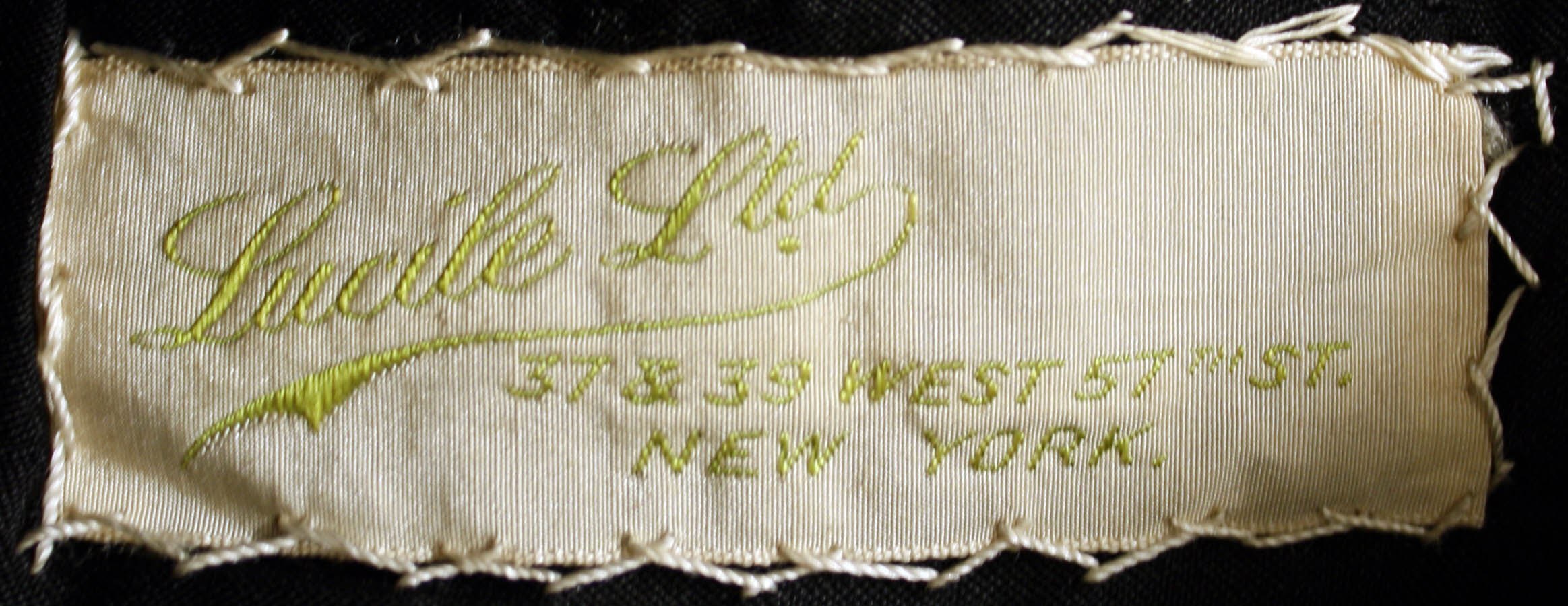Nahaufnahme von Gewebe mit einem Etikett, auf dem likely der Name des Kleidungsstücks steht.